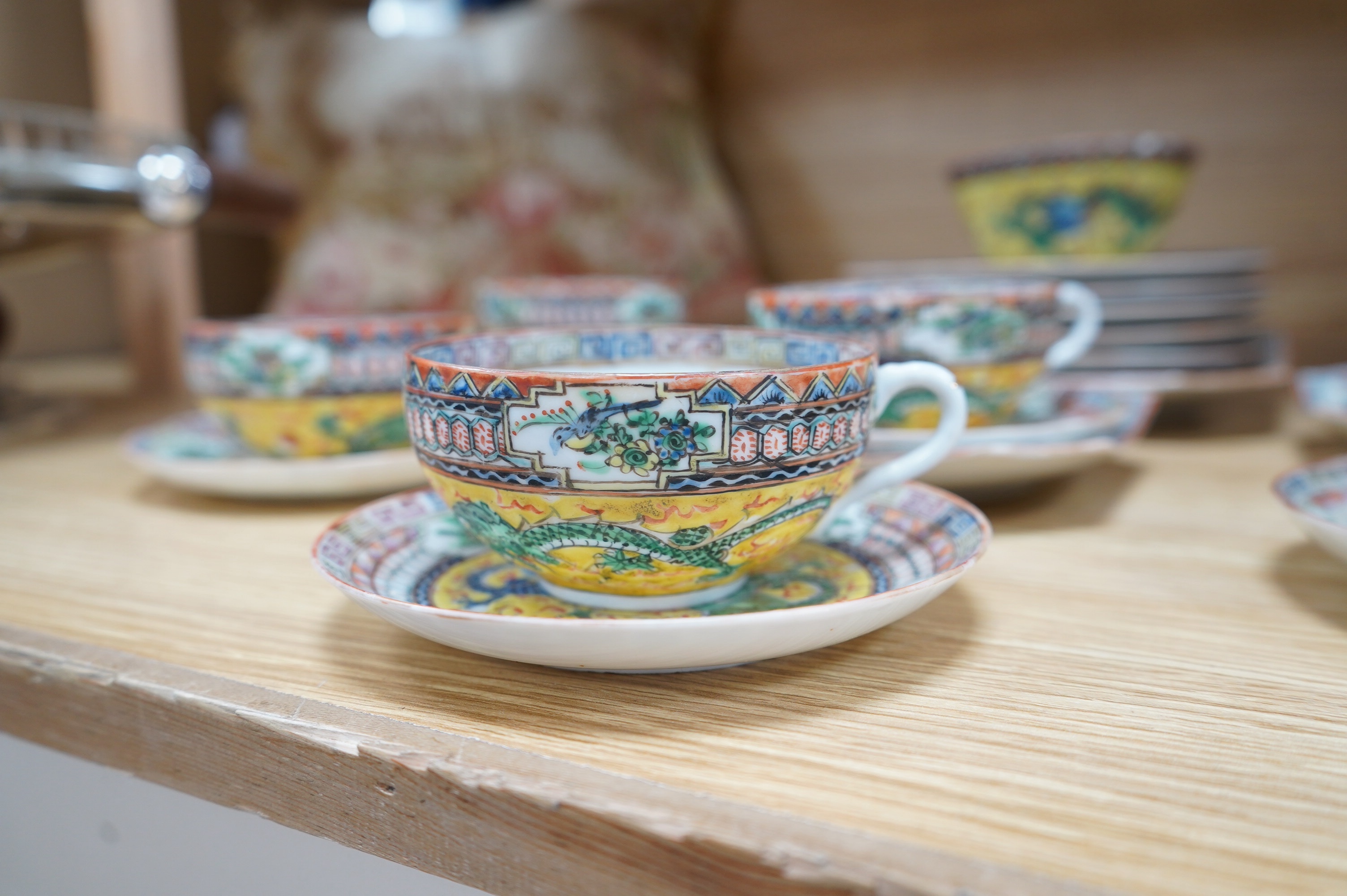 An early 20th century Chinese eggshell porcelain part tea set, with a yellow ground and coloured dragons (22). Condition - cups have slight chipping to top edges